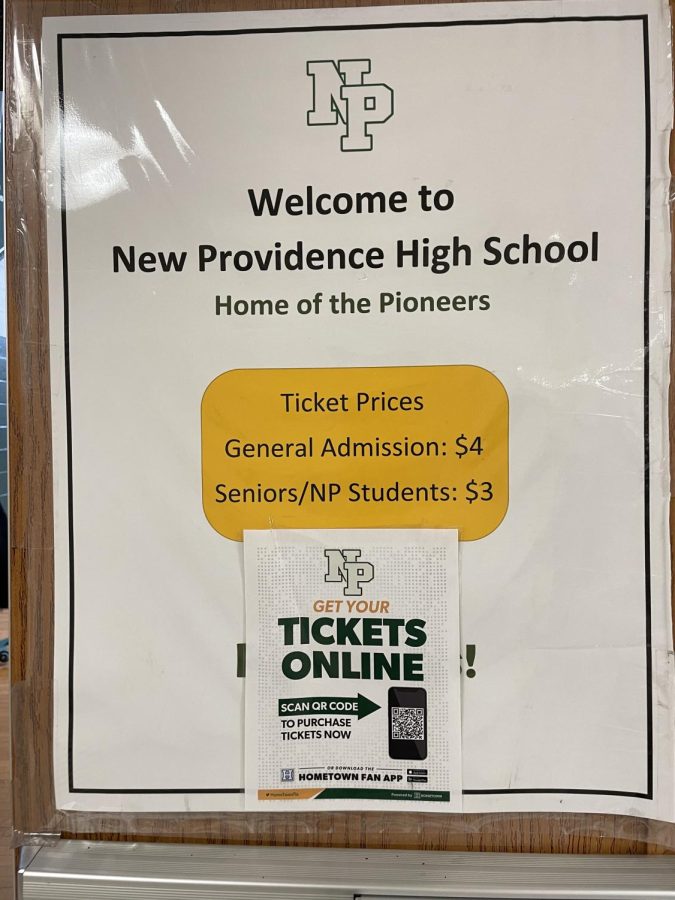 A ticket price sign hangs on the door of the high school gym. 