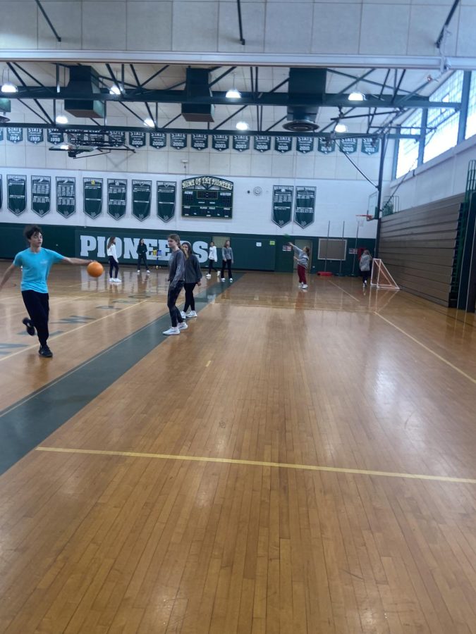 Students in the midst of playing speedball in gym.