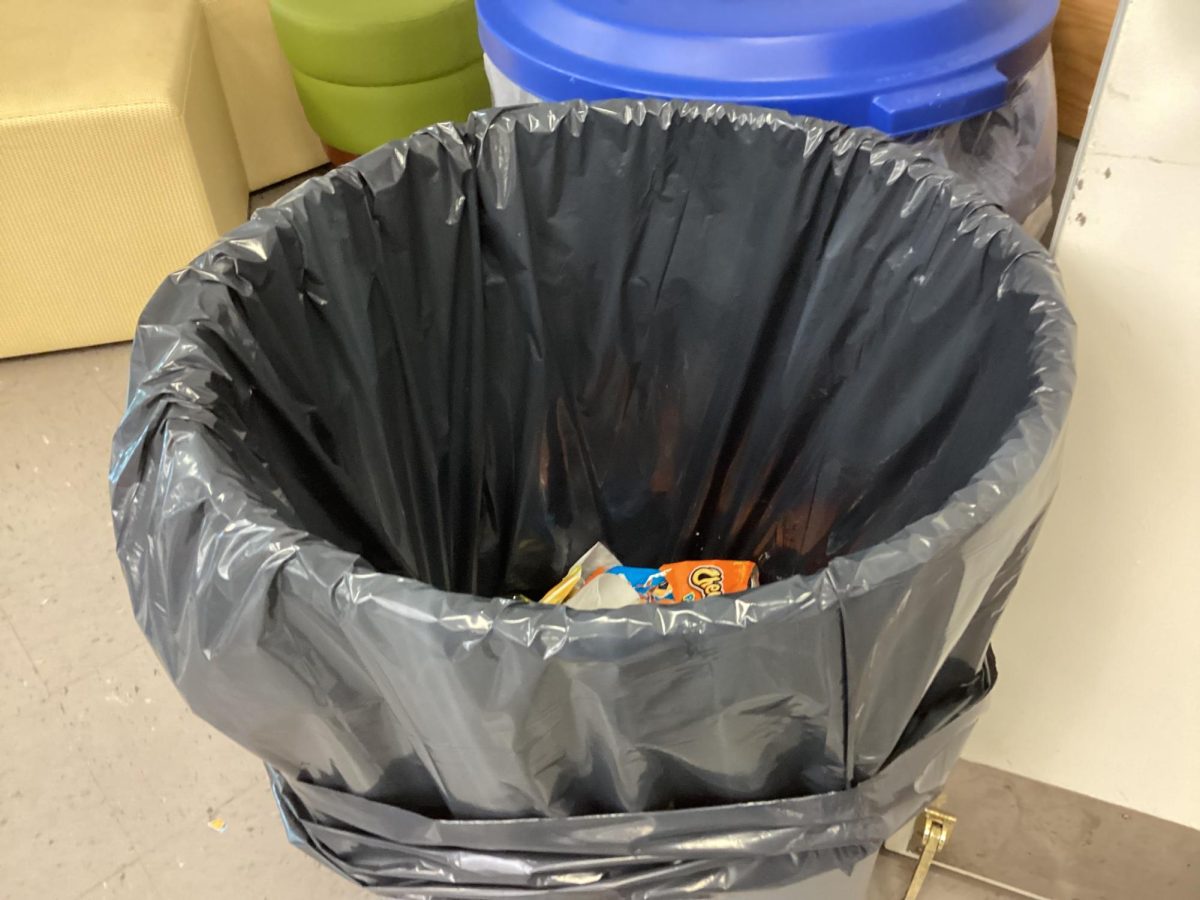 Student throws away the empty salad container.