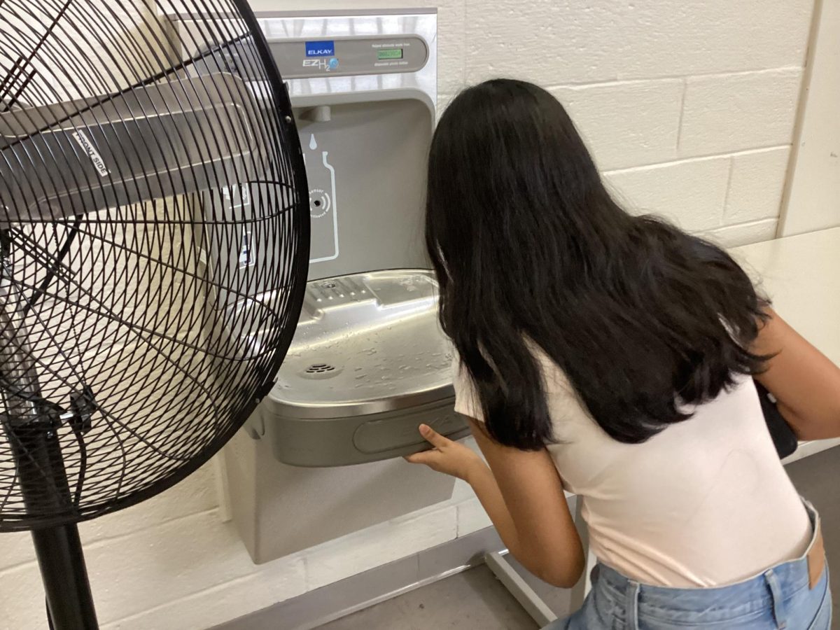 Student grabs a quick drink of water.