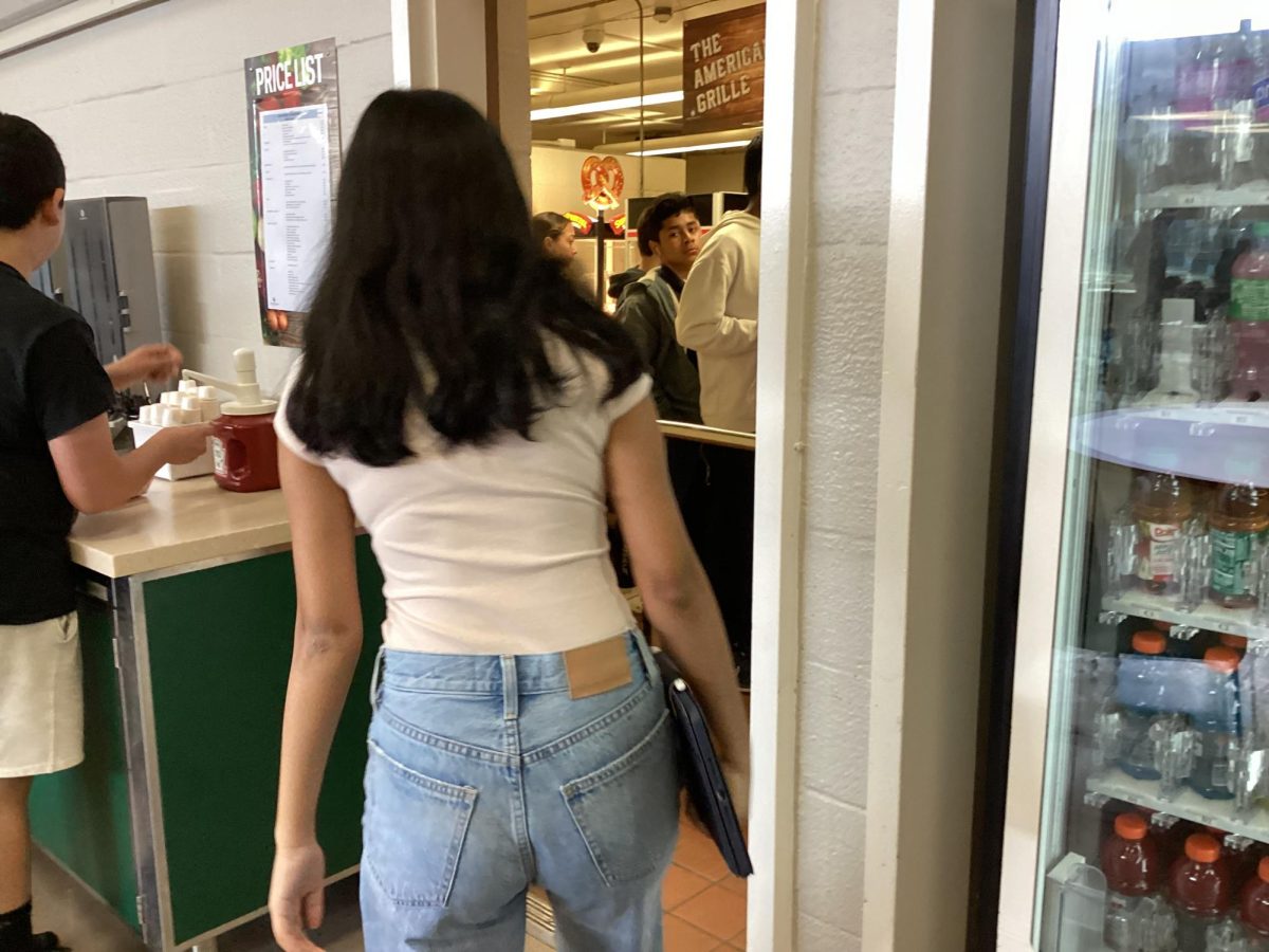 Student walks onto lunch line to buy lunch and a drink.
