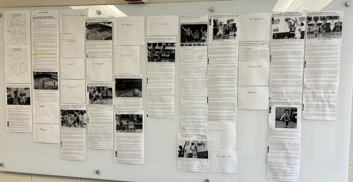 numerous news articles posted on a whiteboard about New Providence athletics 